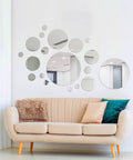 Decorative display of 32 Piece Removable Acrylic Mirror Wall Stickers Round Tiles Silver Medium Size For Home Bathroom Living Room Bedroom TV Backdrop Dope Decor Easy Peel Self Adhesive No Residue above a beige sofa.