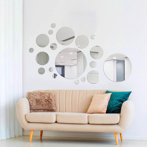 Decorative display of 32 Piece Removable Acrylic Mirror Wall Stickers Round Tiles Silver Medium Size For Home Bathroom Living Room Bedroom TV Backdrop Dope Decor Easy Peel Self Adhesive No Residue above a beige sofa.