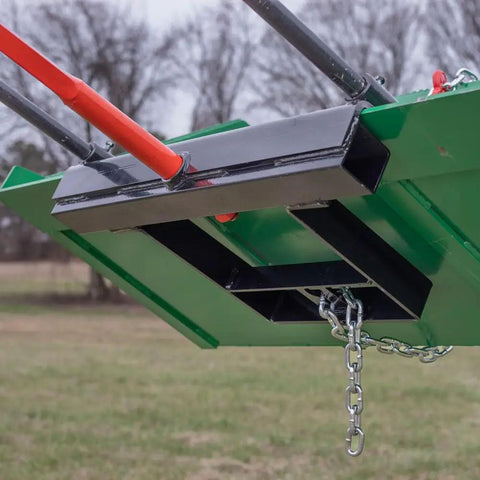 Close-up of Hay Bale Spear Frame Attachment For Universal Front Loader Buckets, highlighting heavy-duty steel and chain detail.