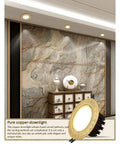Top Shelf 9 Piece LED Recessed Downlights Featuring Round Brass Baffle Trims And Solid Copper Panels in modern decor setting.
