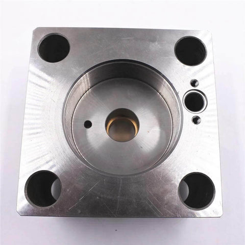 Waterjet intensifier end bell assembly (right), metal block with central bore and four mounting holes