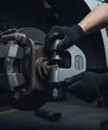 Pro Grade Brake Clevis Pin Press Tool used on semi truck brake system by technician wearing gloves. Fits Kenworth Peterbilt Freightliner Mack.