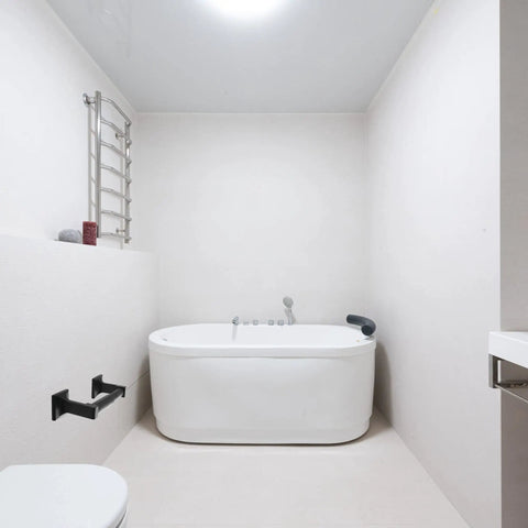 Matte Black Toilet Paper Holder Wall Mount With Double Post Design installed in modern white bathroom