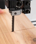 Close-up of 56 7/8 Inch 1/4 Inch Wide 24 TPI Bandsaw Blade cutting wood, showing precision and clean cut.