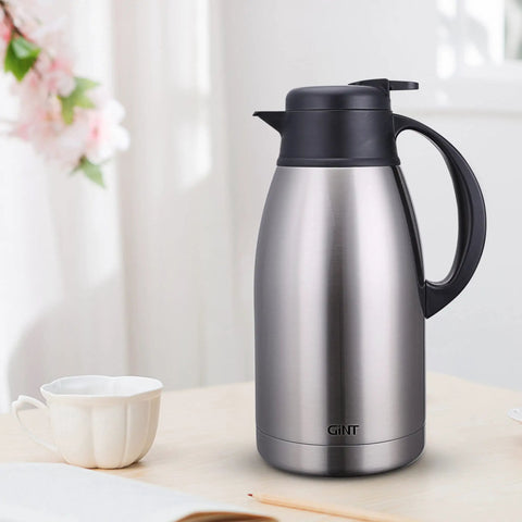 Stainless Steel Thermal Coffee Carafe With Double Wall Vacuum Insulation Keeps Your Brew Piping Hot Up To 12 Hours Or Cold Up To 24 Hours 65 Oz One Point Nine Liter Leak Proof Lid Silver on kitchen counter.