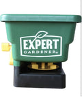 Front view of green handheld seed spreader for lawns and gardens with 6 lb capacity, covers up to 1100 sq ft per load