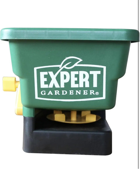 Front view of green handheld seed spreader for lawns and gardens with 6 lb capacity, covers up to 1100 sq ft per load
