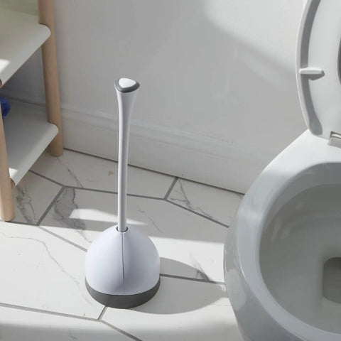 Heavy Duty Toilet Plunger With Hideaway Holder Caddy beside toilet on tiled floor