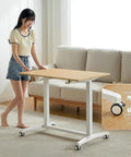 Electric Sit Stand Desk Offering Smooth Height Adjustment, Mobile Rolling Computer Workstation For Home Office with caster mechanism.