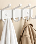 Hella Sturdy Wall Mount Coat Rack Featuring Heavy Duty Double Steel Hooks For Backpack Storage And Rust Proof Coating For Mudroom Storage That Handles Maximum Load Zero Fuss, white hooks with towel and beige coat.