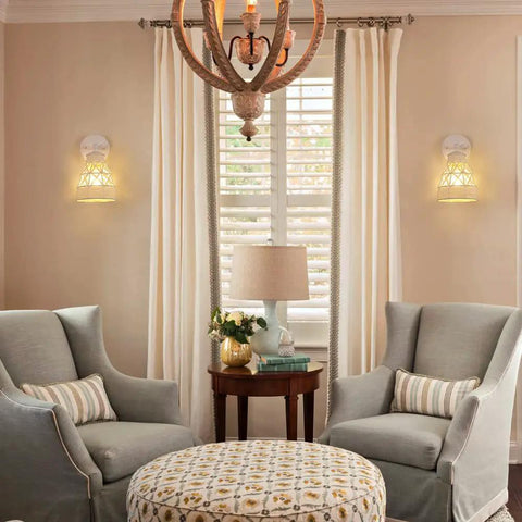 White Wall Sconces Set Of 2 With Adjustable 240 Degree Swing Arm Dope Boho Rattan Cage Lamps in a living room setting