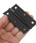 A person holding black stainless steel cabinet door hinge with screws for easy opening and closing foldable butt hinges for wooden box doors.