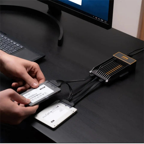 Compact SATA Y Cable For Single Board Computers And Tiny PC Builds, Dual Power And Data Splitter, Ultra Clean Wiring, Ideal For Tight Workspaces And Sleek Setups. Two 2.5-inch SSDs connected on a desk.