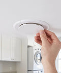 Peel And Stick Round Access Cover Plate 6 Inch for Drywall Ceiling installation, self-adhesive ABS panel being applied.