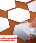 Peeling protective film from 24 Piece Hexagon Acrylic Mirror Wall Decals Set For Living Room And Bedroom Self Adhesive Removable Reflective Stickers