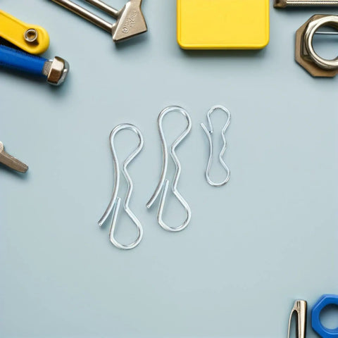 Beefy Bow Tie Cotter Pin And Heavy Duty Deck Clip Fasteners Kit including retainer pins on light blue background with tools