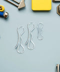 Cotter Pin Hardware Kit with Bow Tie Lock Clips and Spring Pins on light blue background with tools scattered around.