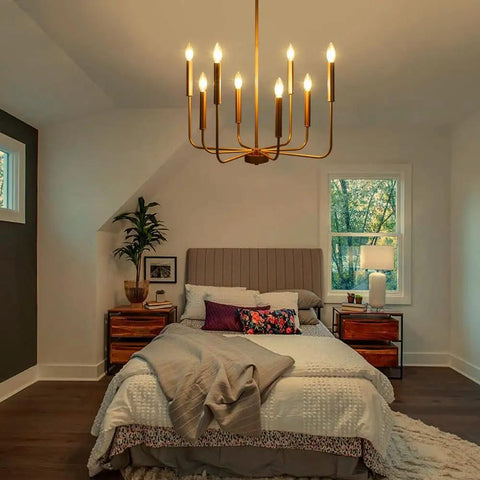 Gold 8 Light Farmhouse Chandelier With Modern Brass Candle Design for bedroom, ceiling mount, warm lighting, adjustable height.