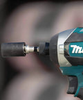 Beefy Impact Driver Socket Adapter Quarter Inch Square Drive Two Inch Length With Rock Solid Retention Ball attached to a drill