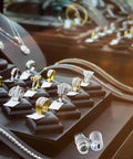 60x Pocket Microscope With LED Light For Jewelry And Currency Inspection displayed with rings and necklaces on a jewelry counter.