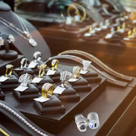 60x Pocket Microscope With LED Light For Jewelry And Currency Inspection displayed with rings and necklaces on a jewelry counter.