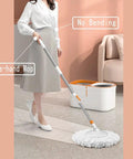 Woman using Spin Mop And Bucket Set With Wringer System And 61 Inch Extendable Stainless Steel Handle For Easy No Sweat Home Floor Cleaning Includes 5 Replacement Mop Heads And 1 Cleaning Brush For Quick Streak Free Results on carpet