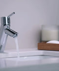 Talis S Modern Timeless Easy Clean 7-Inch Tall Bathroom Sink Faucet 1-Handle Chrome Finish flowing water in modern bathroom