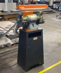 Kickass Dust Collection System For Eight Inch Angle Grinders featuring a black base and gray motor, designed for capturing dust effectively.