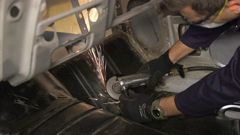 Pro Grade 4 Inch Pneumatic Air Angle Grinder With High Torque Ball Bearing Motor in use on auto body, sparks flying.