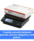 Top Notch Digital Postal Shipping Scale For Boxes And Parcel Mailing 55 Lb Capacity With Dead On 0.01 Lb Precision bright LCD screen displaying weight with a small flat rate box on top.