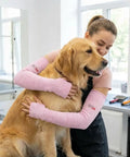 Mechanic wearing Heavy Duty Cut Resistant Arm Sleeves With Thumb Holes For Mechanics And Glass Handling Shielding Delicate Skin Straight Up Like Body Armor In Pink Pair, holding a golden retriever.