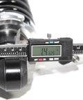 Close-up of digital caliper measuring rear left and right street rod coil over shocks with black coated springs 400 pound rate.