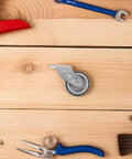 Heavy Duty Sliding Barn Door Guide Roller with screws on wooden surface, showing anti-sag bottom support and durable steel wheel.