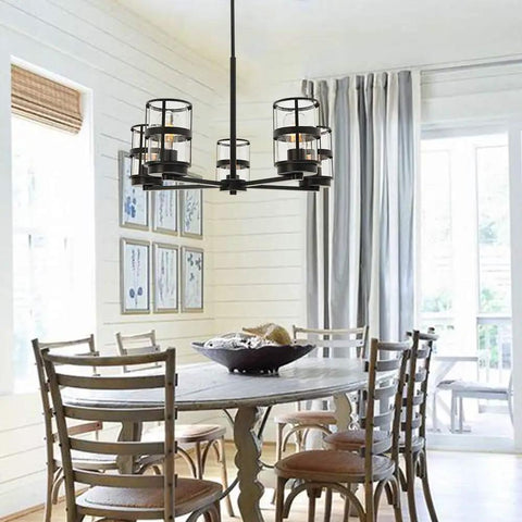 Five Light Pendant Lighting Fixture With Vintage Farmhouse Clear Glass Shades over dining table in bright kitchen