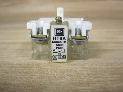 Heavy Duty Ht8a Normally Open Contact Block For Thirty Millimeter Push Buttons And Switches Industrial Grade Replacement Hardware on wooden backdrop.