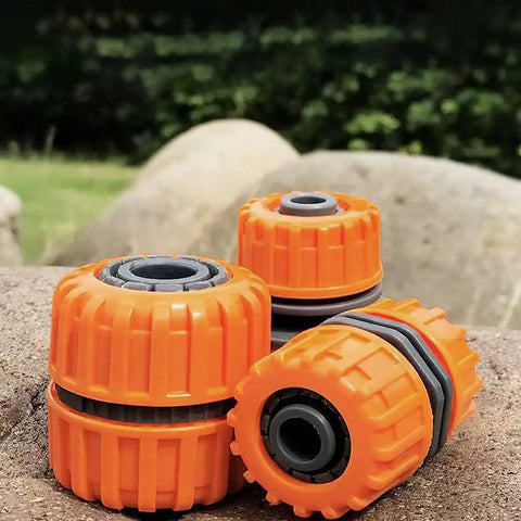 Garden Hose Repair Kit For 1/2 Inch Hoses, Quick Connect Connectors, orange durable PVC fittings on rock background