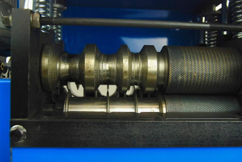 Close-up of the WS 212 Wire Stripping Machine With Nine Cutting Channels for Copper showing dual rollers and metal cutting area.