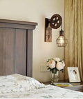 Set Of Two Retro Industrial Pulley Wall Lamps Crafted From Heavy Duty Vintage Metal With A Weathered Rustic Finish perfect for bedside lighting.