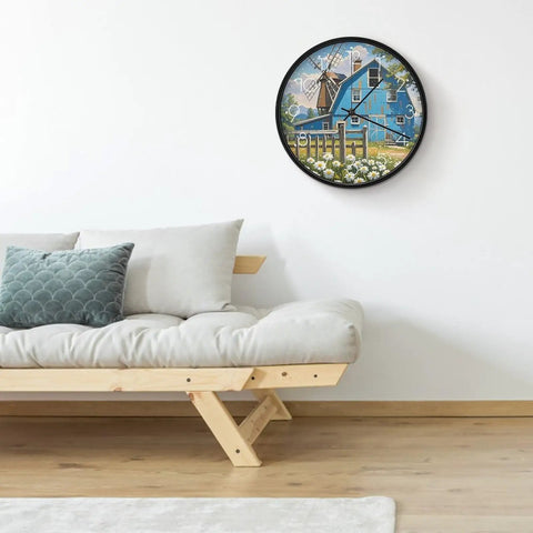 Dead Quiet Sweep Wall Clock With A Sweet Rural Blue Valley Warehouse Vibe Non Ticking Round Timepiece Battery Operated Design With Quick Install Brackets For Chill Home Office Classroom Spaces on a wall above a cozy sofa.
