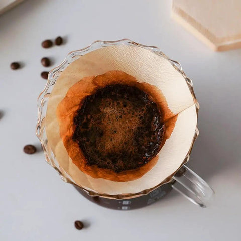 View of Cone Coffee Filters Size Four Natural Unbleached Pack Of 100 For Your 12 Cup Drip Coffee Makers with brewed coffee.