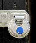 Close-up of Diskus Hardened Stainless Steel Padlock Keyed Alike Pack Of 2 With 360 Degree Protection And Anti Cut Plate on a shed latch