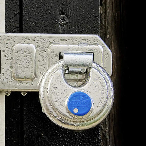 Close-up of Diskus Hardened Stainless Steel Padlock Keyed Alike Pack Of 2 With 360 Degree Protection And Anti Cut Plate on a shed latch