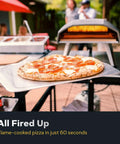 Koda 12 Inch Gas Pizza Oven For Outdoor Cooking With 28 Millibar Regulator And Gas Hose Portable Outdoor Pizza Oven Foundry Black Ready In Minutes Reaches 950 Degrees F So You Can Bake Authentic Stone Baked Pizzas In About 60 Seconds On The Patio with pizza being cooked.