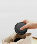 Person placing hard protective earphone case for earbuds and headphones into bag, ultra compact carrying pouch, dustproof, water resistant