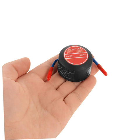 Low Key No Stress Automatic Aerosol Fire Extinguisher 2 Pack With Heavy Duty Back Adhesive Auto Extinguishing Patch in hand view.