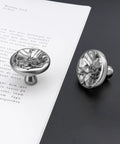 Flower Shaped Cabinet Knobs 8 Pack In Brushed Satin Nickel on paper background, close-up view