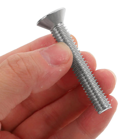 Hand holding a screw from the 10 Piece Wear-Resistant Stainless Steel Flat Head Socket Screws Set For Furniture Assembly, 5/16-18.