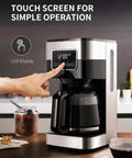 10 Cup Programmable Coffee Maker With Regular And Strong Brew Auto Shut Off Permanent Filter Easy LCD Touch Screen Great For Home Or Office Silver Finish displayed with finger pressing touch screen on kitchen counter.