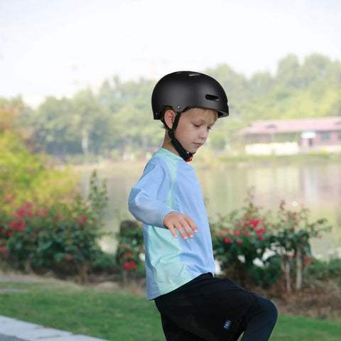 Child wearing Lightweight Multi Sport Helmet With Hard Abs Shell And Shock Absorbing Foam in outdoor setting.