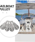 4pc Stainless Steel Pulley Blocks For Kayak And Boat Anchor, Heavy Duty Marine Grade Bearing Roller Wheel Rope Pulley System Accessories For Easy Sailing, Towing, Rigging, And Canvas Adjustments displayed with a view of a sailboat cockpit.